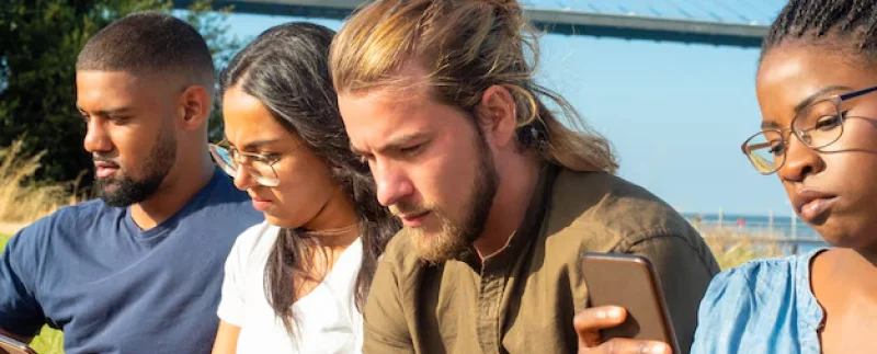 a group of people checking their phone