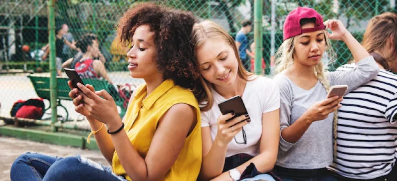 some teenagers scrolling on their phones