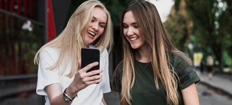 two girls checking their phones